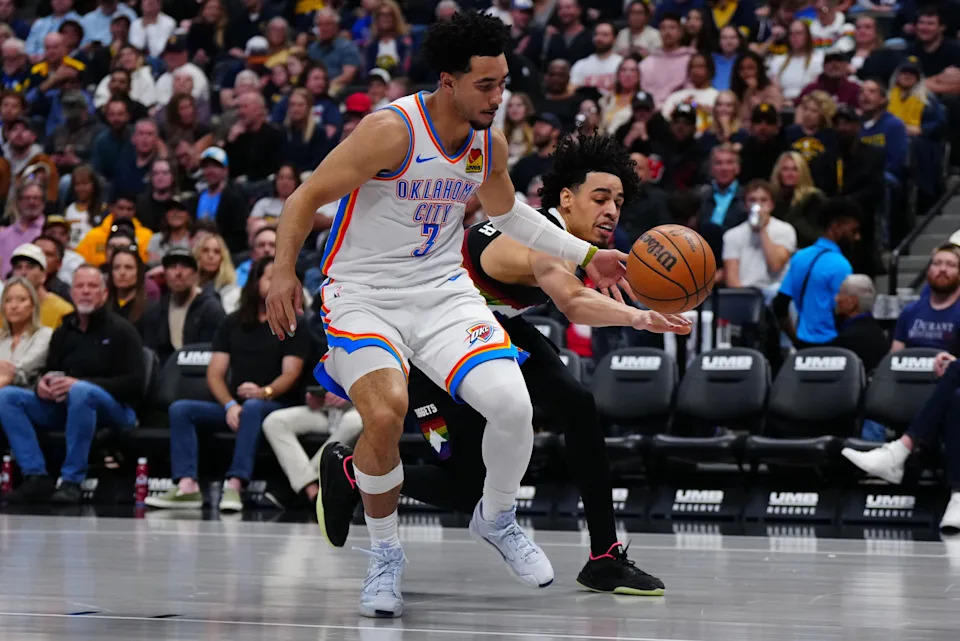 Apr 10, 2026; Denver, Colorado, USA; Denver Nuggets guard Julian Strawther (3) knocks the ball away from Oklahoma City Thunder guard Jared McCain (3) in the second quarter at Ball Arena. Mandatory Credit: Ron Chenoy-Imagn Images