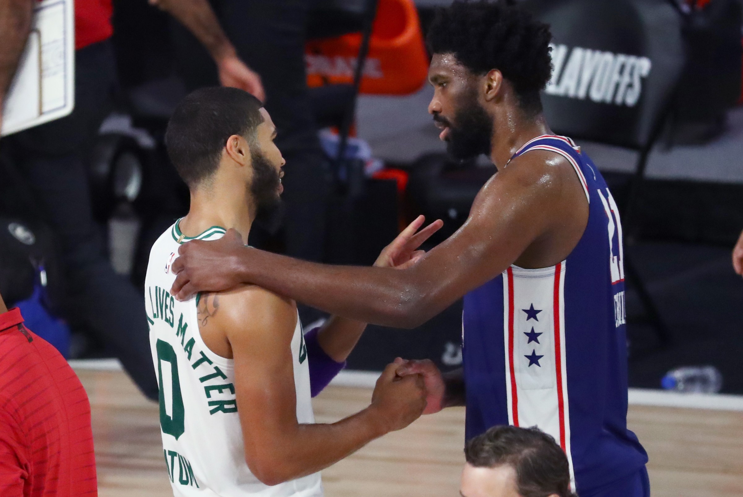 LAKE BUENA VISTA, FLORIDA - AUGUST 23: Jayson Tatum #0 of the Boston Celtics speaks with Joel Embiid #21 of the Philadelphia 76ers after the game in Game Four of the first round of the playoffs at The Field House at ESPN Wide World Of Sports Complex on August 23, 2020 in Lake Buena Vista, Florida. NOTE TO USER: User expressly acknowledges and agrees that, by downloading and or using this photograph, User is consenting to the terms and conditions of the Getty Images License Agreement. (Photo by Kim Klement-Pool/Getty Images)
