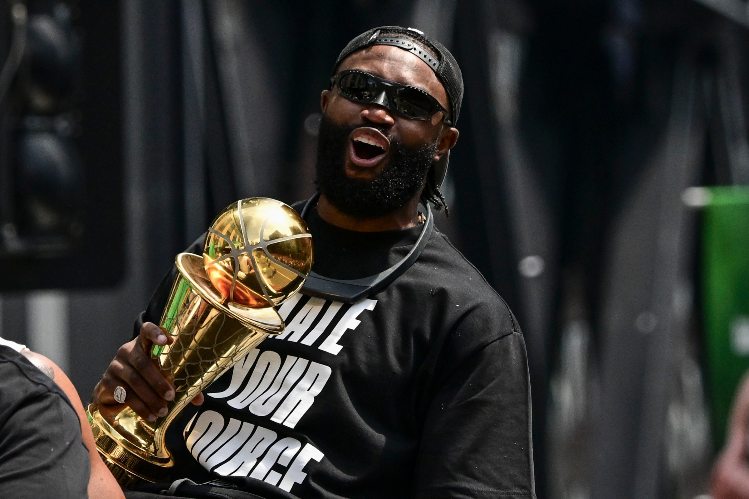 BOSTON, MASSACHUSETTS - JUNE 21: Jaylen Brown #7 of the Boston Celtics reacts as he holds the NBA Finals Most Valuable Player trophy during the 2024 Boston Celtics championship parade following their 2024 NBA Finals win on June 21, 2024 in Boston, Massachusetts. (Photo by Billie Weiss/Getty Images)