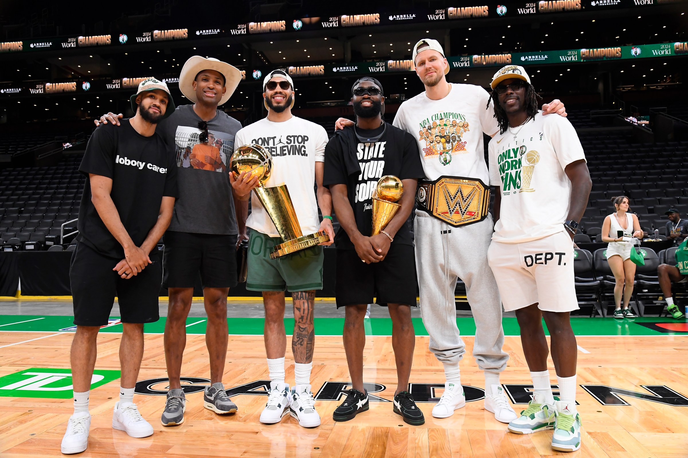 BOSTON, MA - JUNE 21: Derrick White #9, Al Horford #42, Jayson Tatum #0, Jaylen Brown #7, Kristaps Porzingis #8, and Jrue Holiday #4 of the Boston Celtics pose for a photograph with the Larry O’Brien Trophy and the Bill Russell Finals MVP Trophy before the 2024 Boston Celtics championship parade on June 21, 2024 in Boston, Massachusetts. NOTE TO USER: User expressly acknowledges and agrees that, by downloading and or using this photograph, User is consenting to the terms and conditions of the Getty Images License Agreement. Mandatory Copyright Notice: Copyright 2024 NBAE (Photo by Brian Babineau/NBAE via Getty Images)