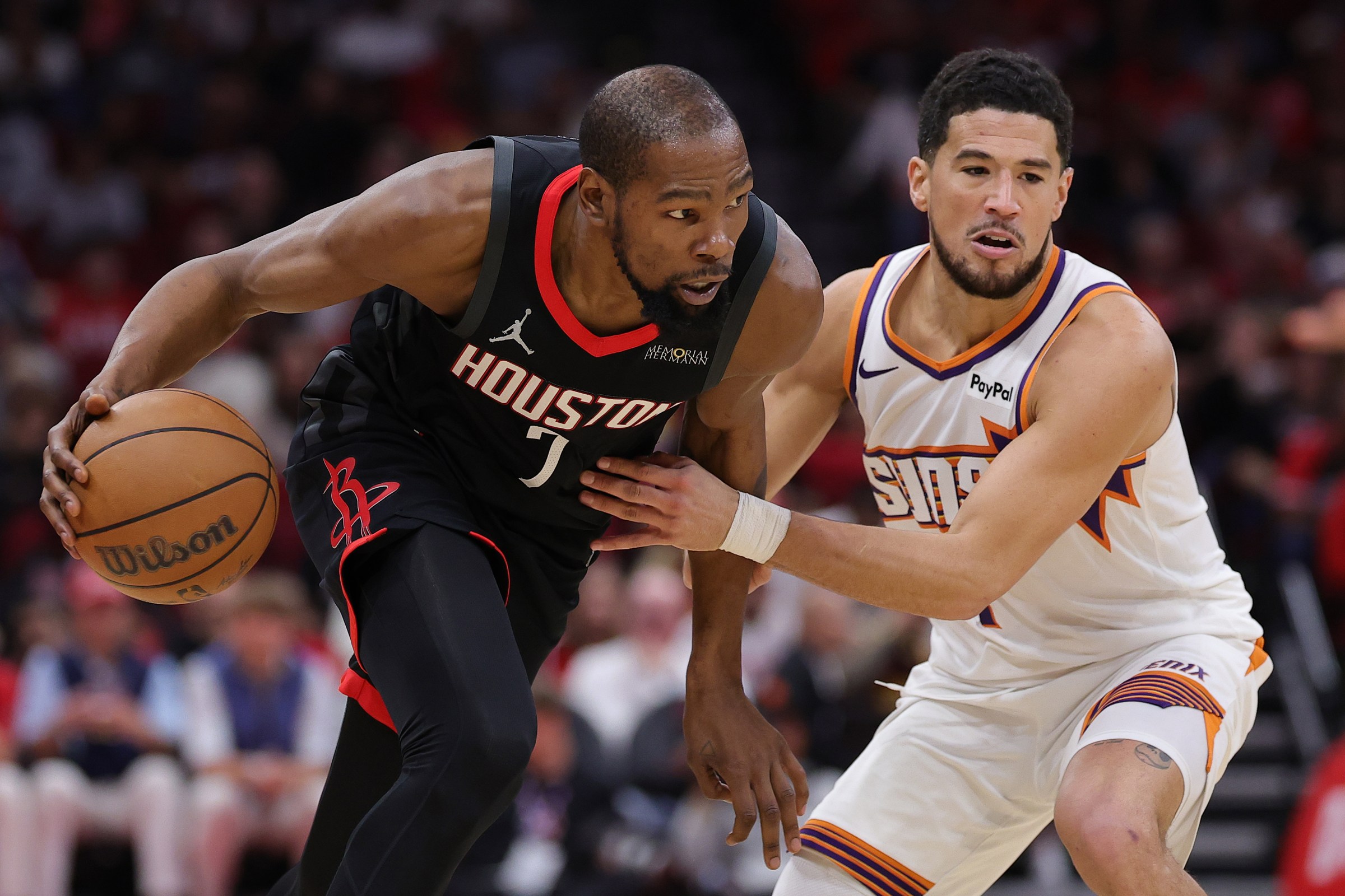 HOUSTON, TEXAS - JANUARY 05: Kevin Durant #7 of the Houston Rockets drives against Devin Booker #1 of the Phoenix Suns during the second half at Toyota Center on January 05, 2026 in Houston, Texas. NOTE TO USER: User expressly acknowledges and agrees that, by downloading and or using this photograph, User is consenting to the terms and conditions of the Getty Images License Agreement. (Photo by Alex Slitz/Getty Images)