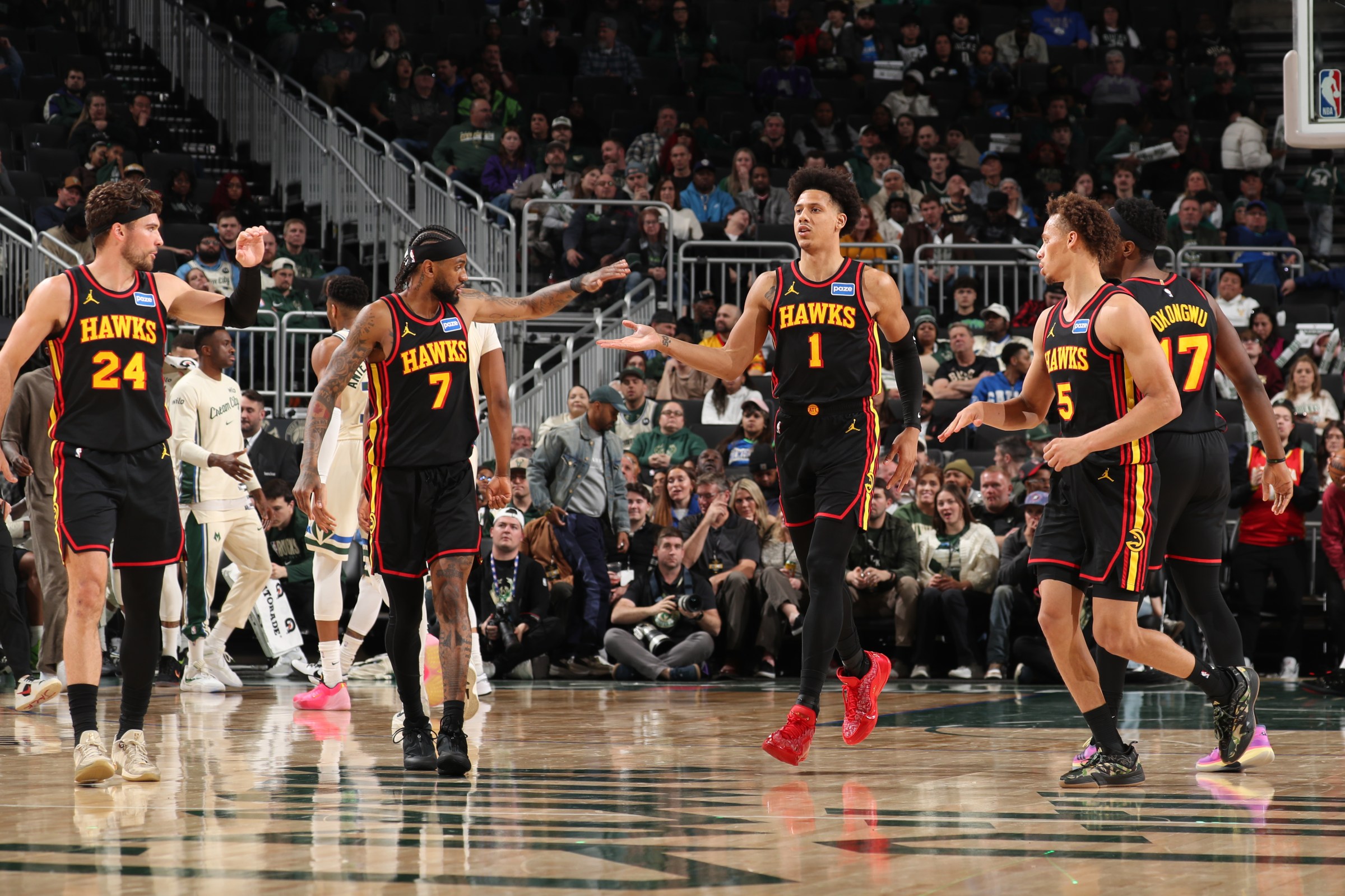 MILWAUKEE, WI - MARCH 4: Jalen Johnson #1, Nickeil Alexander-Walker #7, Corey Kispert #24, and Dyson Daniels #5 of the Atlanta Hawks high five during the game against the Milwaukee Bucks on March 4, 2026 at Fiserv Forum Center in Milwaukee, Wisconsin. NOTE TO USER: User expressly acknowledges and agrees that, by downloading and or using this Photograph, user is consenting to the terms and conditions of the Getty Images License Agreement. Mandatory Copyright Notice: Copyright 2026 NBAE (Photo by Gary Dineen/NBAE via Getty Images).