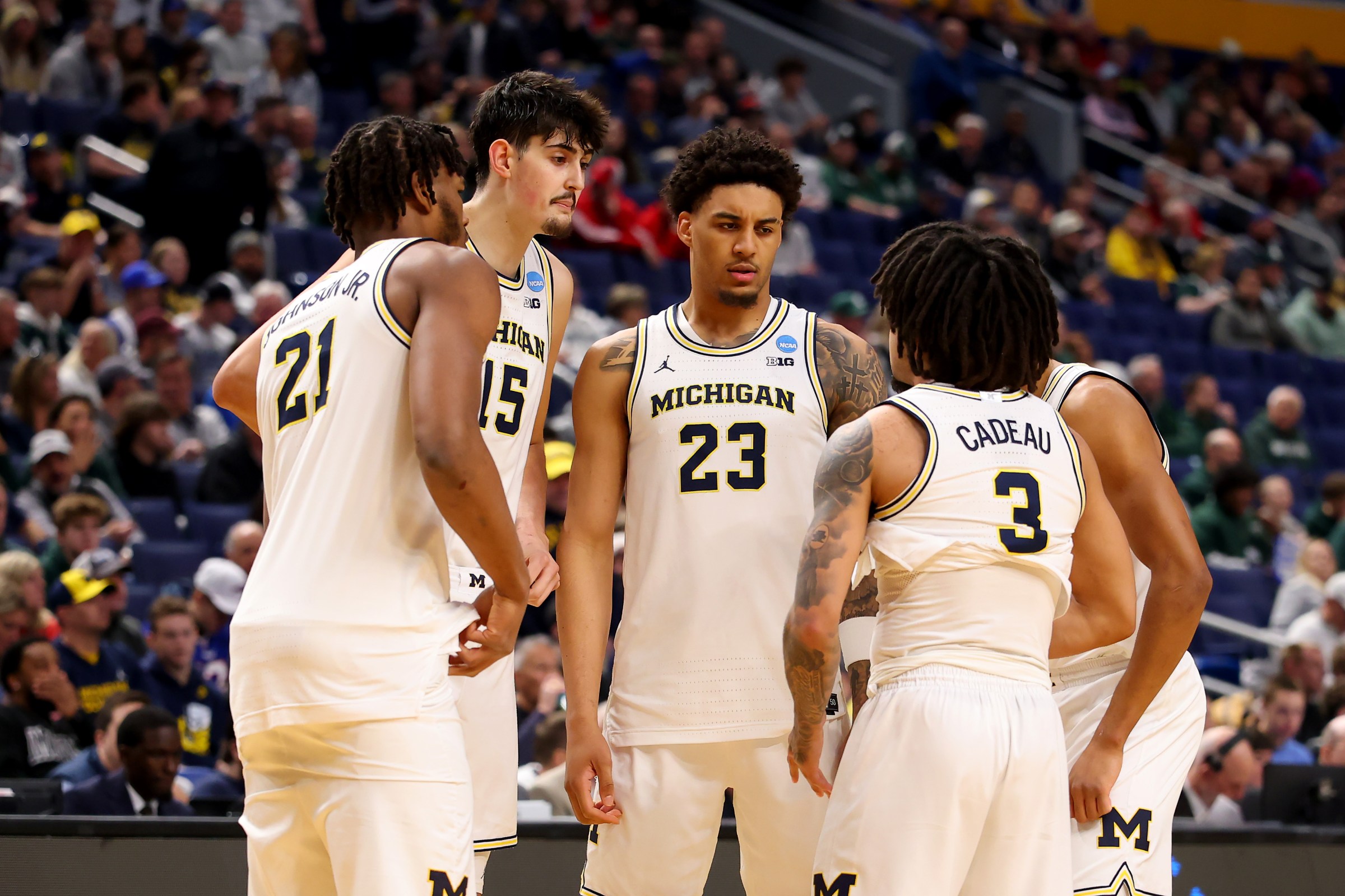 BUFFALO, NEW YORK - MARCH 21: Yaxel Lendeborg #23 of the Michigan Wolverines talks with teammates Morez Johnson Jr. #21, Aday Mara #15 and Elliot Cadeau #3 against the Saint Louis Billikens during the first half in the second round of the 2026 NCAA Men’s Basketball Tournament at KeyBank Center on March 21, 2026 in Buffalo, New York. (Photo by Gregory Shamus/Getty Images)