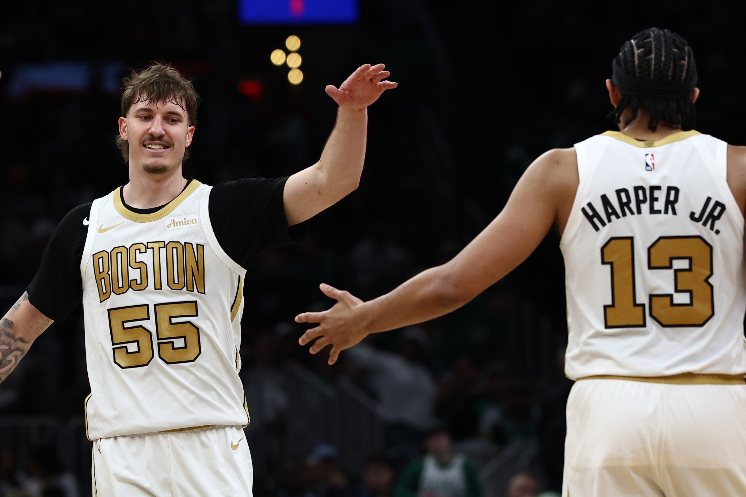 BOSTON, MA - APRIL 12: Baylor Scheierman #55 and Ron Harper Jr. #13 of the Boston Celtics celebrate during the second half of a 113-108 win over the Orlando Magic at TD Garden on April 12, 2026 in Boston, Massachusetts. NOTE TO USER: User expressly acknowledges and agrees that, by downloading and/or using this Photograph, user is consenting to the terms and conditions of the Getty Images License Agreement. (Photo By Winslow Townson/Getty Images)
