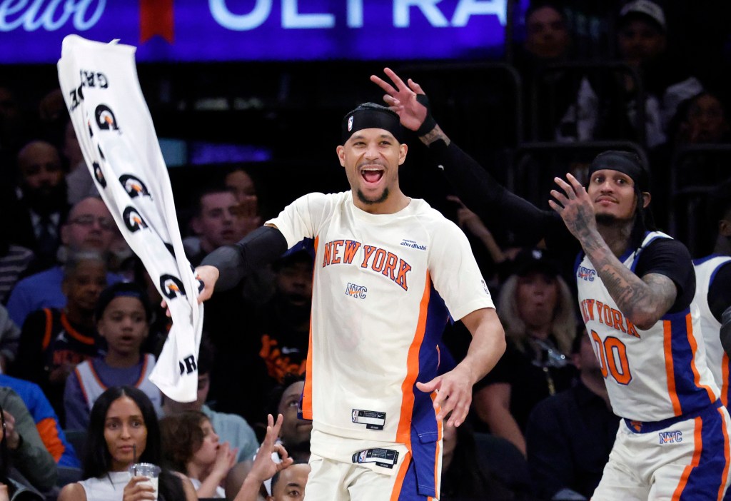 Basketball players Josh Hart and Jordan Clarkson of the New York Knicks react after scoring a three-point shot.