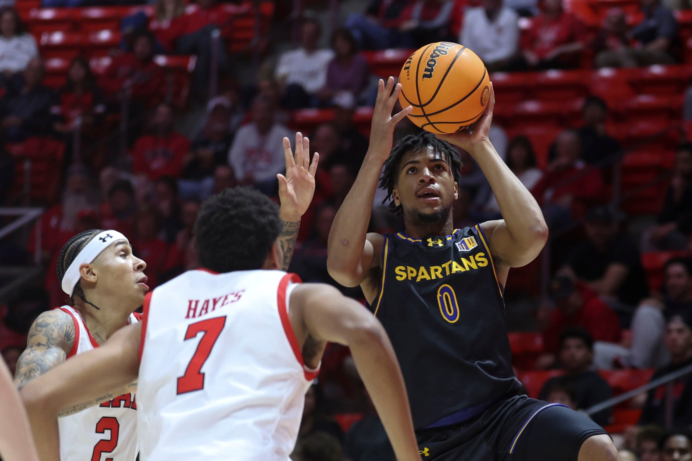 Nov 3, 2025; Salt Lake City, Utah, USA; San Jose State Spartans guard Colby Garland (0) goes to the basket against Utah Utes guard Terrence Brown (2) and forward Josh Hayes (7) during the first half at Jon M. Huntsman Center. Mandatory Credit: Rob Gray-Imagn Images