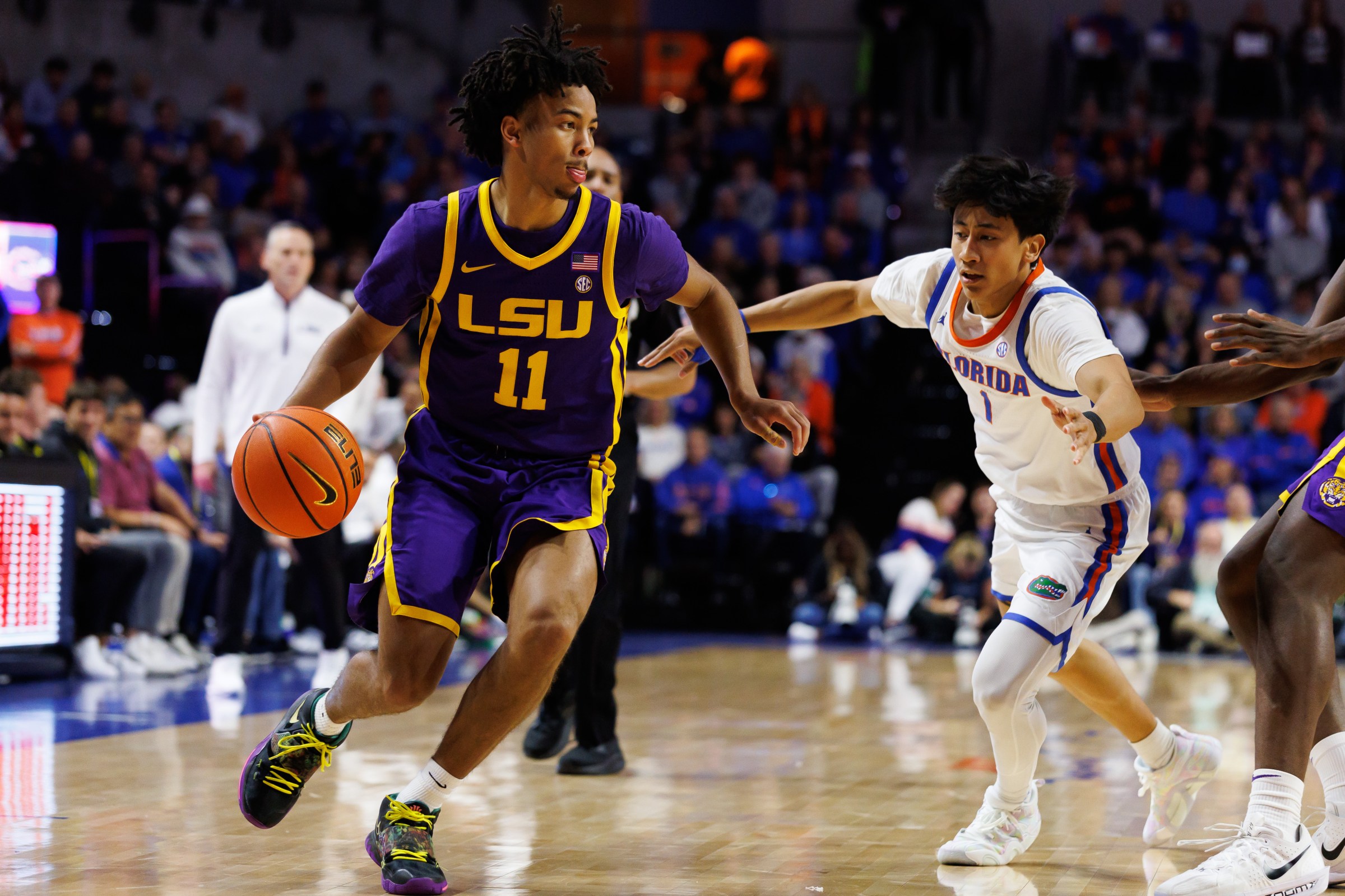 Jan 20, 2026; Gainesville, Florida, USA; Louisiana State Tigers guard Dedan Thomas Jr. (11) drives to the basket past Florida Gators guard Xaivian Lee (1) during the first half at Exactech Arena at the Stephen C. O’Connell Center. Mandatory Credit: Matt Pendleton-Imagn Images