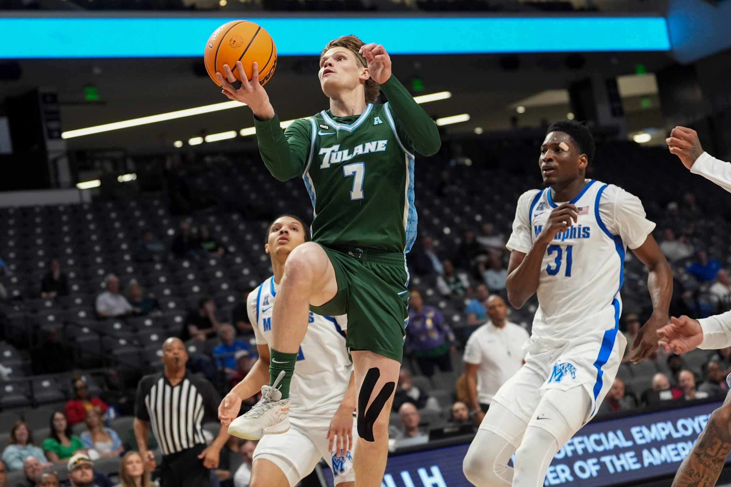 Tulane’s Rowan Brumbaugh (7) goes for a layup during the first round American Conference Tournament game between Memphis and Tulane in Birmingham, Ala, on March 11, 2026.