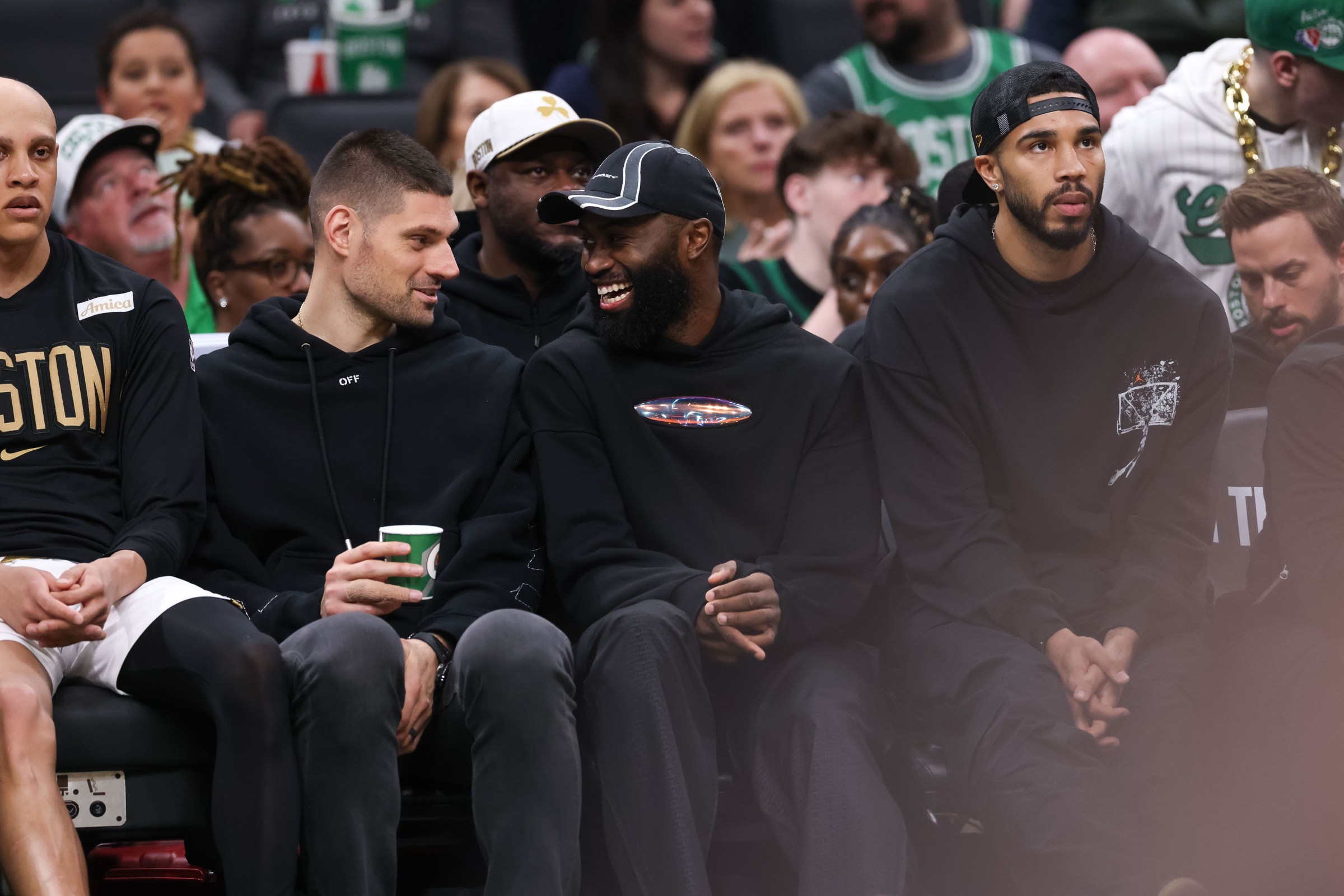 Apr 12, 2026; Boston, Massachusetts, USA; Boston Celtics forward Jaylen Brown (7) and Boston Celtics center Nikola Vucevic (4) talk during the first half against the Orlando Magic at TD Garden. Mandatory Credit: Paul Rutherford-Imagn Images