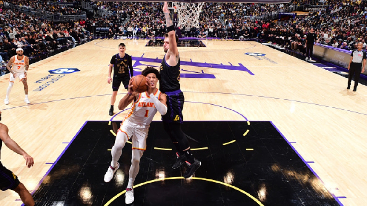 Jalen Johnson #1 of the Atlanta Hawks drives to the basket against Luka Doncic #77 of the Los Angeles Lakers at Crypto.com Arena on January 13, 2026.