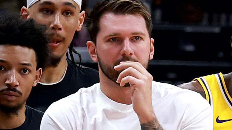 Luka Doncic on Lakers bench during Game 4 vs Rockets amid estimated return status update.