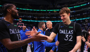 Naji Marshall #13 of the Dallas Mavericks greets Cooper Flagg #32 as they exit the court following a victory over the Los Angeles Lakers at American Airlines Center.