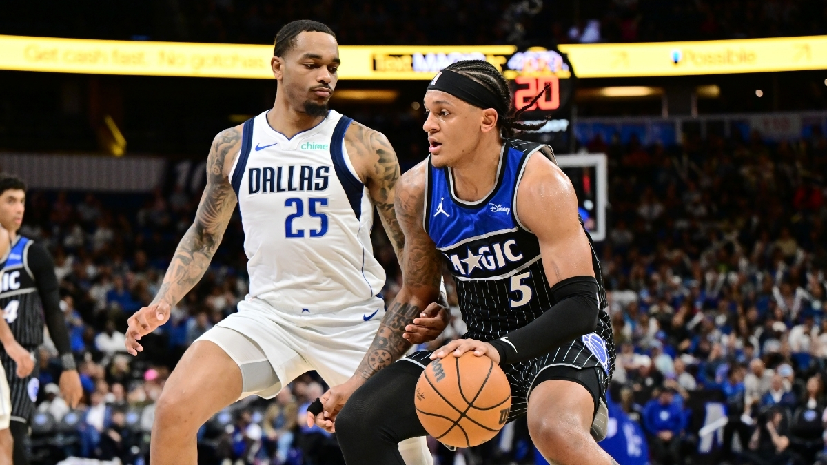 Paolo Banchero of the Orlando Magic dribbles toward the basket while being defended by P.J. Washington of the Dallas Mavericks on March 5, 2026.