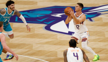 Phoenix Suns guard Collin Gillespie (12) prepares to shoot a 3-point basket during the first half of an NBA basketball game against the Charlotte Hornets in Charlotte, N.C., Thursday, April 2, 2026. (AP Photo/Nell Redmond)