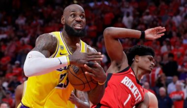 Los Angeles Lakers forward LeBron James, left, immediately signals for a timeout after winning a rebound from Houston Rockets guard Amen Thompson (1) during the second half of Game 3 in a first-round NBA playoffs basketball series Friday April 24, 2026, in Houston. (AP Photo/Michael Wyke)