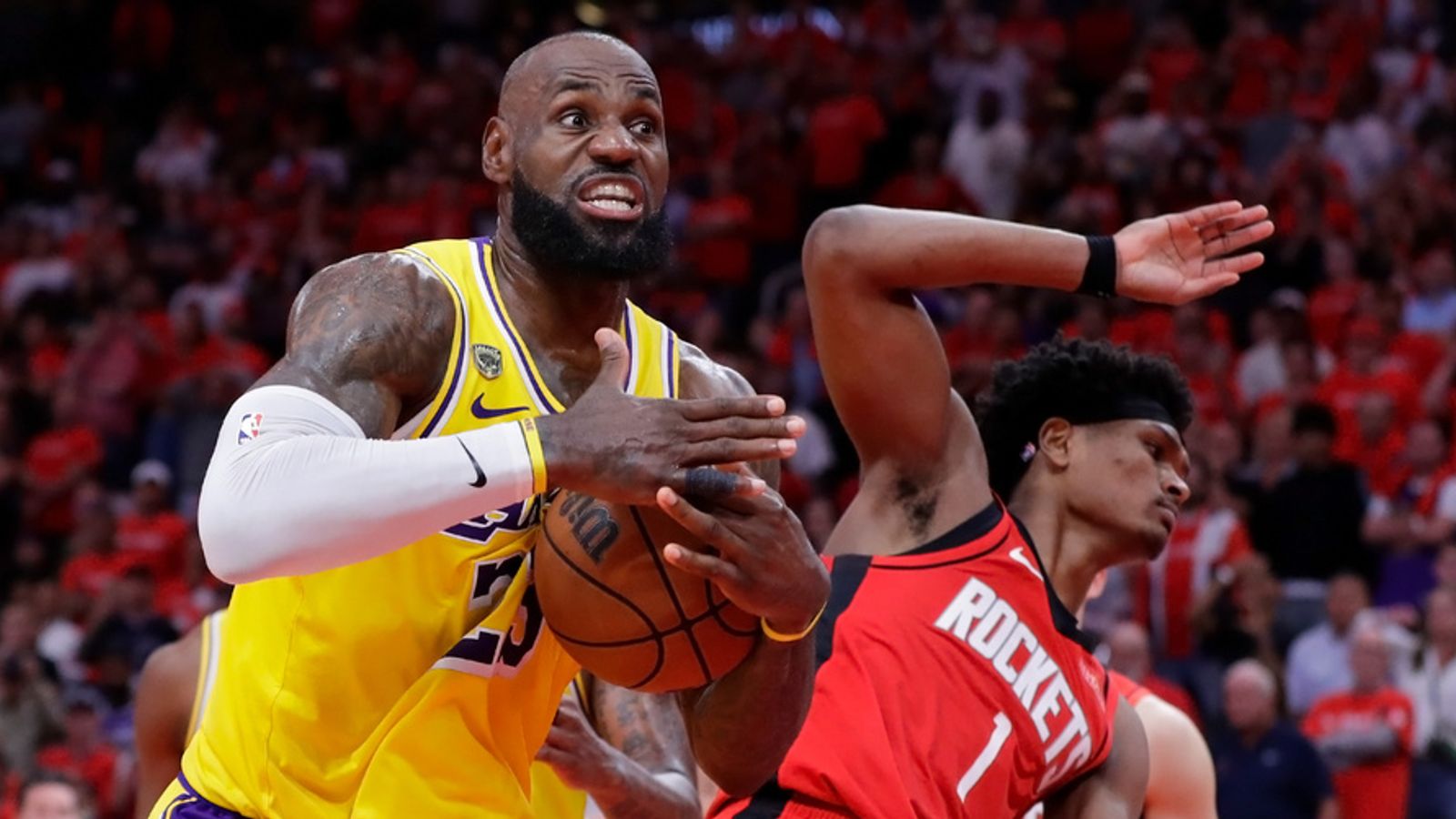 Los Angeles Lakers forward LeBron James, left, immediately signals for a timeout after winning a rebound from Houston Rockets guard Amen Thompson (1) during the second half of Game 3 in a first-round NBA playoffs basketball series Friday April 24, 2026, in Houston. (AP Photo/Michael Wyke)