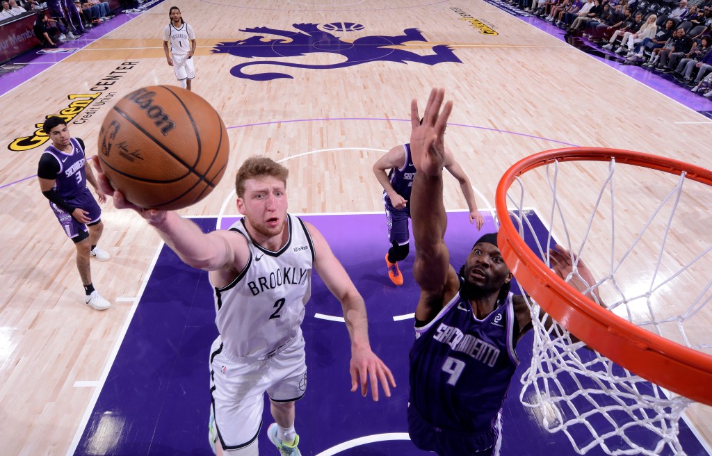 Danny Wolf of the Brooklyn Nets driving to the basket during a game against the Sacramento Kings.