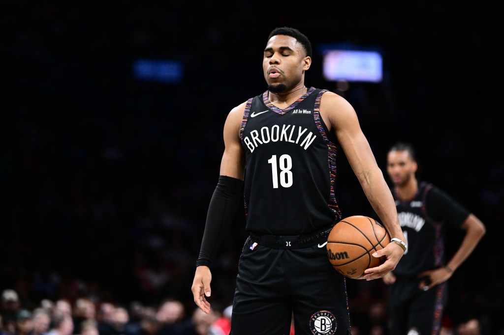 Malachi Smith #18 of the Brooklyn Nets holding a basketball.