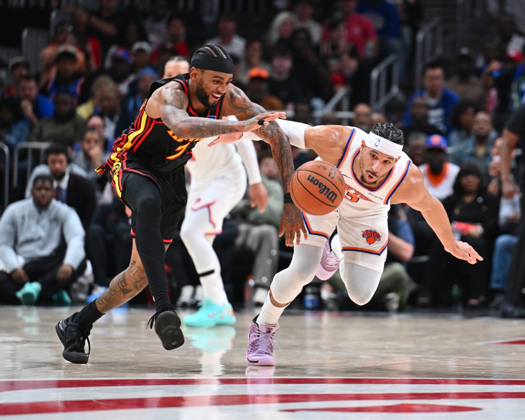 Nickeil Alexander-Walker #7 of the Atlanta Hawks and Josh Hart #3 of the New York Knicks go after a loose ball during the game on April 6, 2026 at State Farm Arena in Atlanta, Georgia.