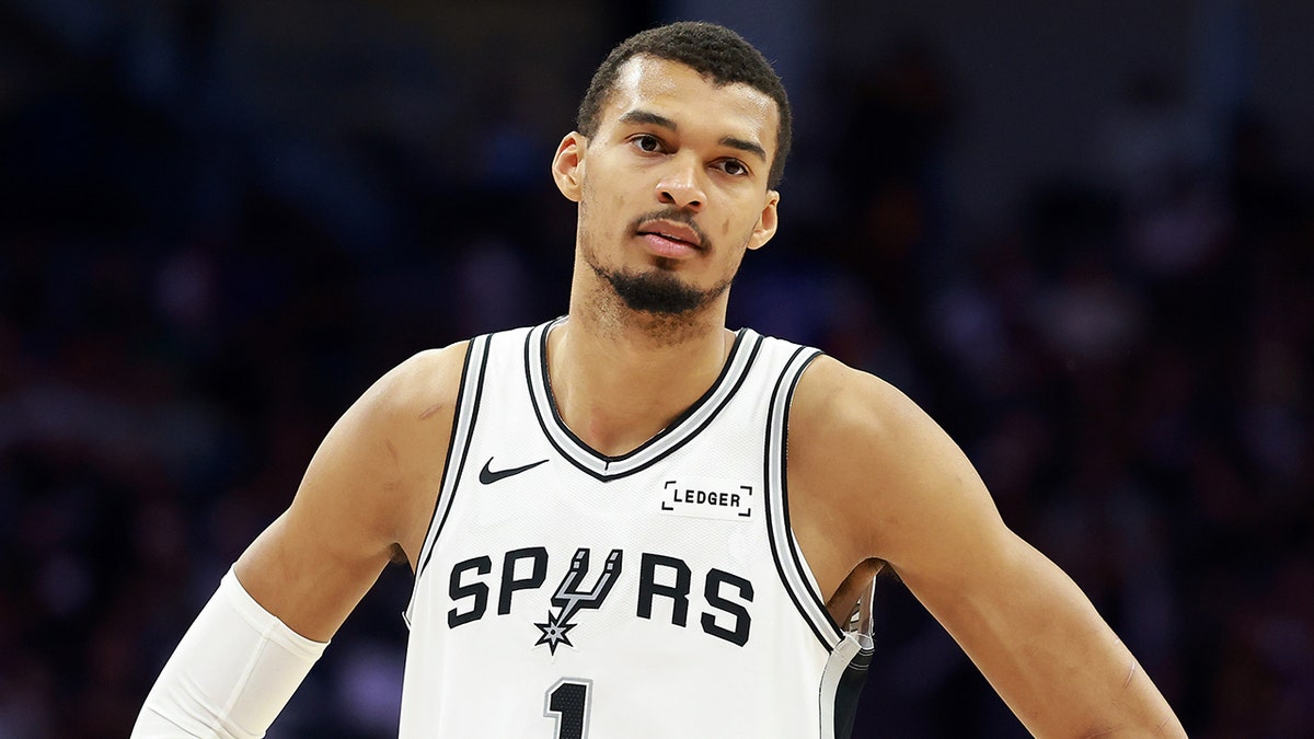 Victor Wembanyama standing on the basketball court during a game.