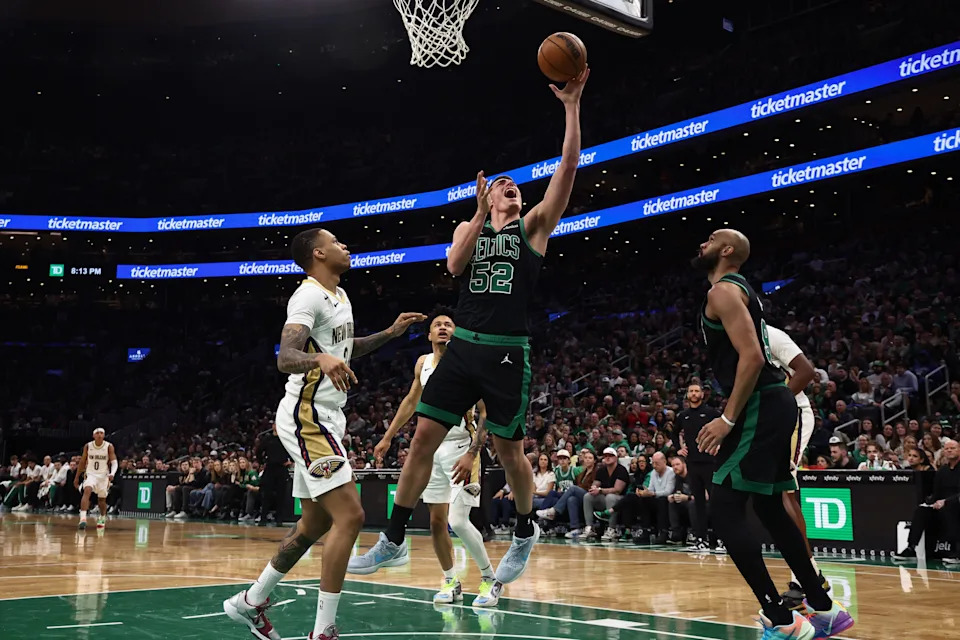 Apr 10, 2026; Boston, Massachusetts, USA; Boston Celtics center Luka Garza (52) goes to the basket past New Orleans Pelicans forward Herbert Jones (2) during the second quarter at TD Garden. Mandatory Credit: Winslow Townson-Imagn Images