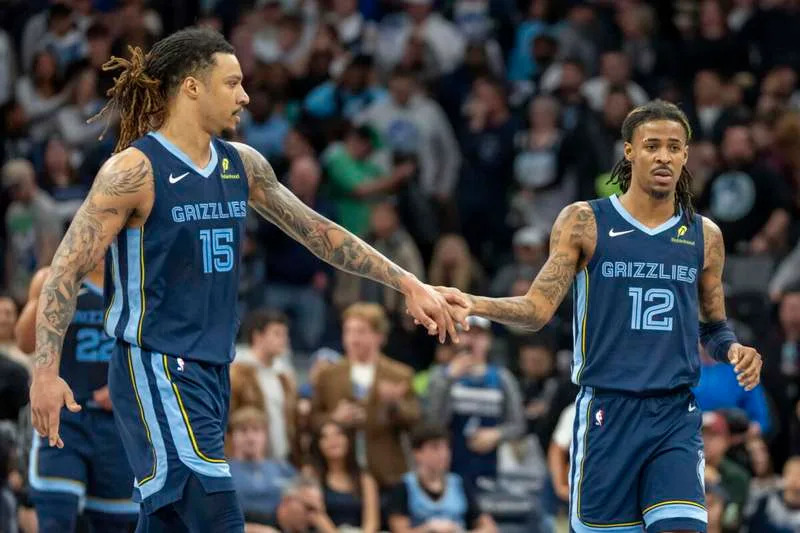 Jan 11, 2025; Minneapolis, Minnesota, USA; Memphis Grizzlies forward Brandon Clarke (15) and guard Ja Morant (12) celebrate after defeating the Minnesota Timberwolves at Target Center. Mandatory Credit: Jesse Johnson-Imagn Images