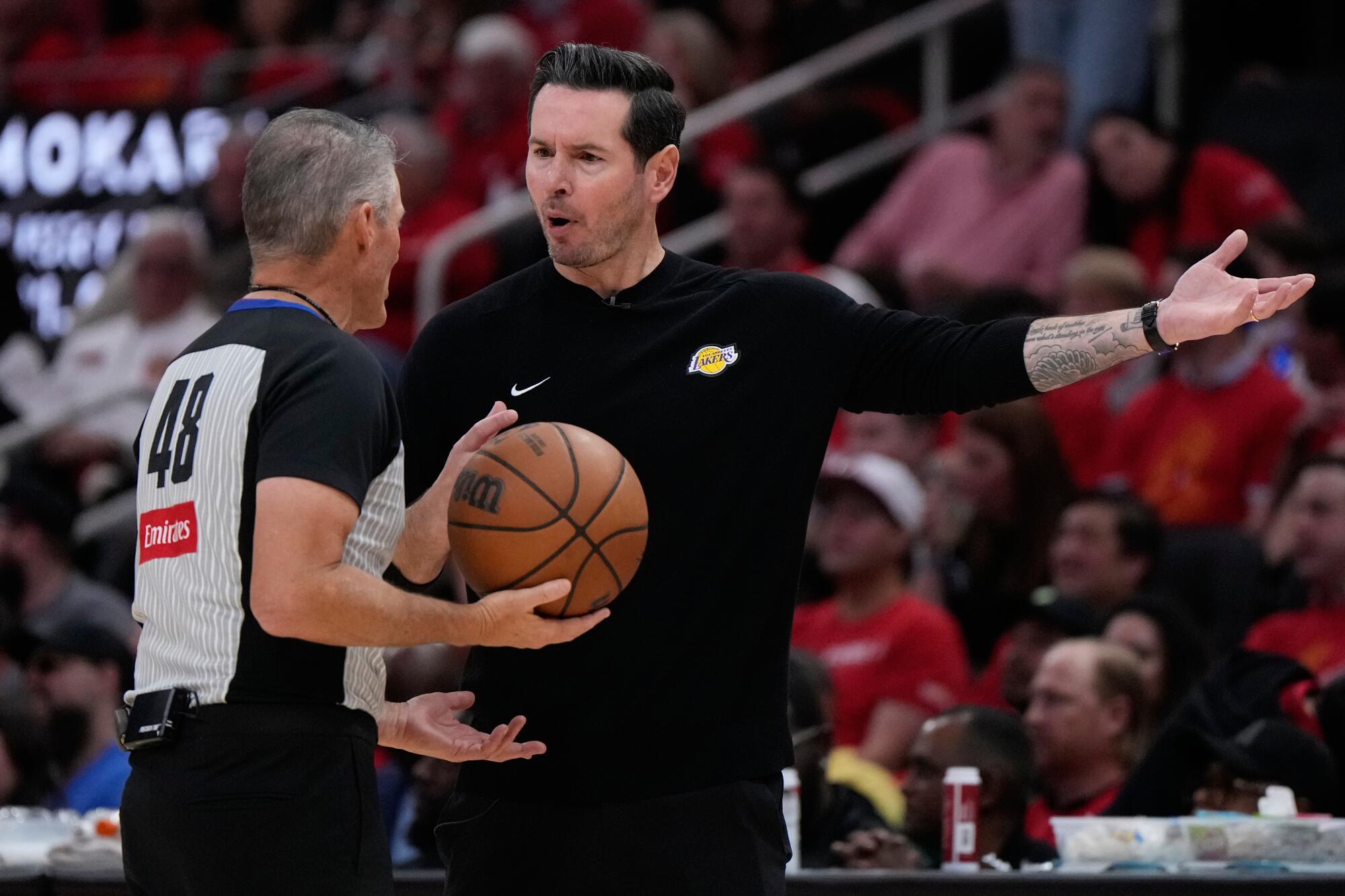 Lakers coach JJ Redick, right, talks with referee Scott Foster, left, during the first half of Game 6.