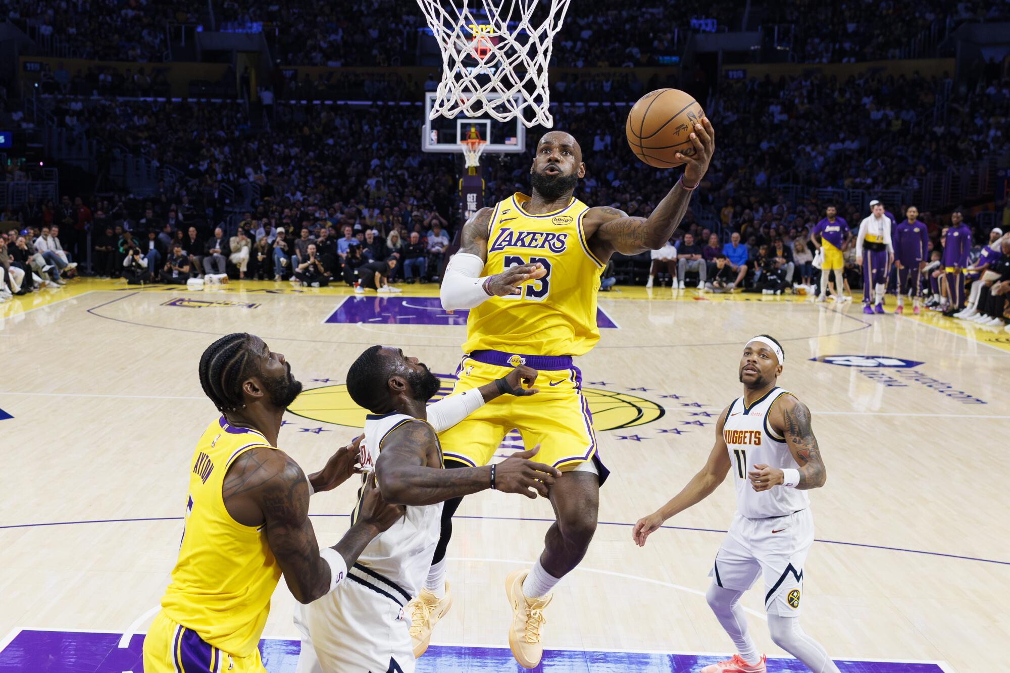 LeBron James scores against the Denver Nuggets at Crypto.com Arena on March 14.