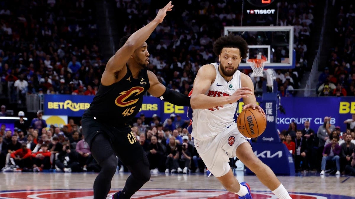 Detroit Pistons PG Cade Cunningham drives to the basket on Cleveland Cavaliers SG Donovan Mitchell in Game 1 of their second-round series of the 2026 NBA Playoffs at Little Caesars Arena in Michigan.