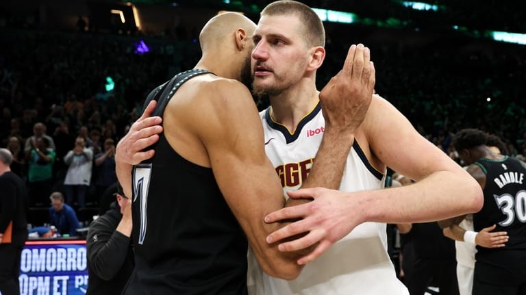 Denver Nuggets center Nikola Jokic, right, and Minnesota Timberwolves center...