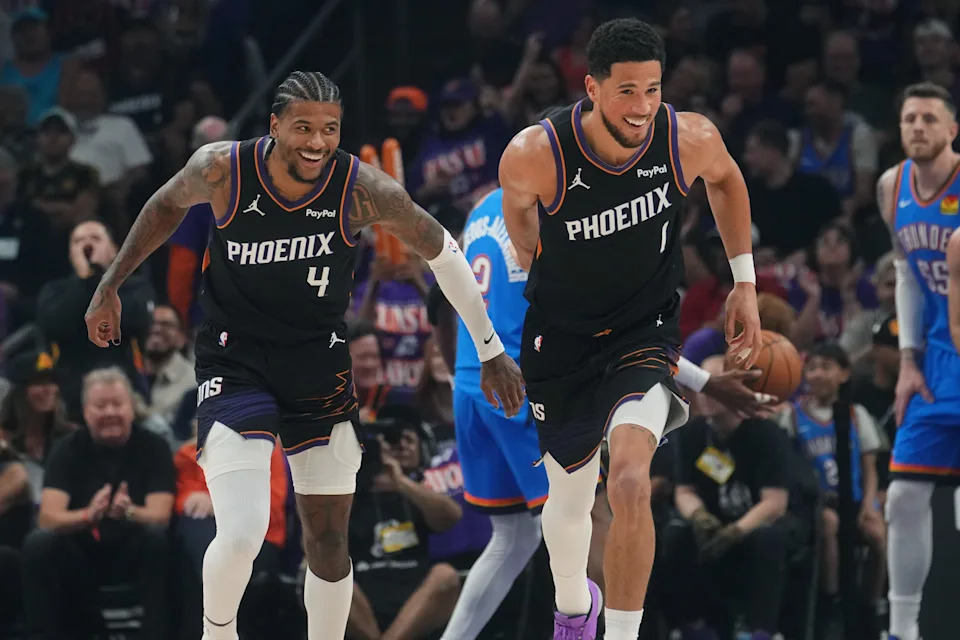 Phoenix Suns guard Devin Booker (1) and teammate Jalen Green (4) smile after scoring against the Oklahoma City Thunder during Game 3 of their playoff series at Mortgage Matchup Center in Phoenix on April 25, 2026.