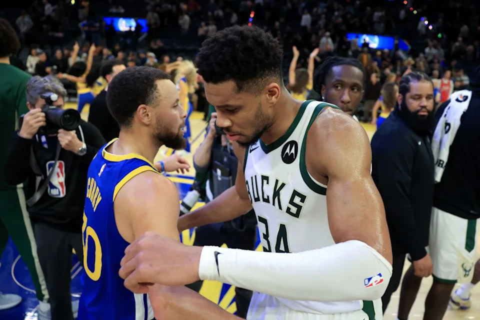 Giannis Antetokounmpo of the Milwaukee Bucks congratulates Stephen Curry of the Golden State Warriors