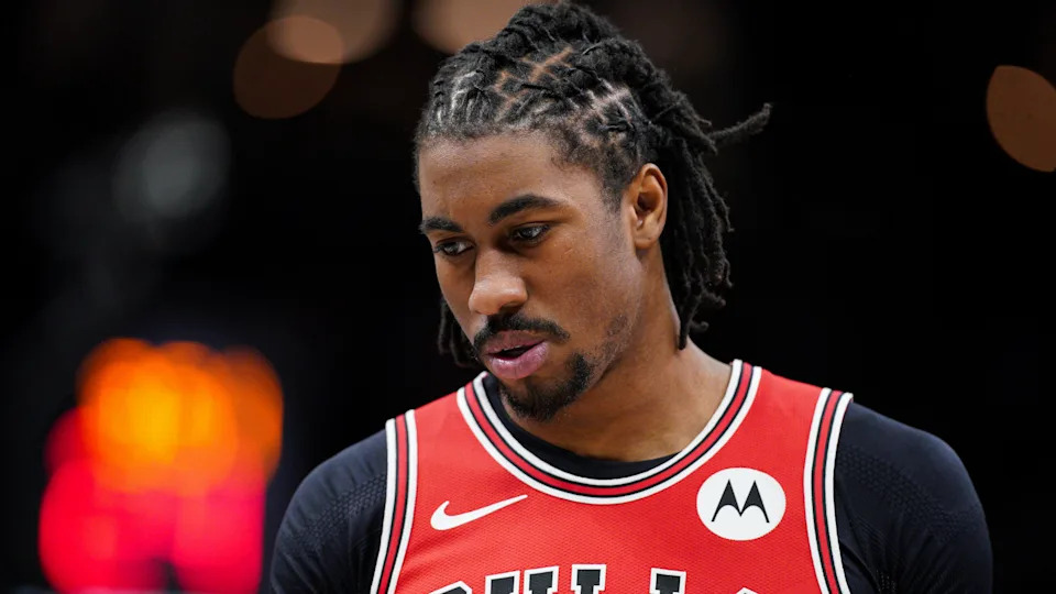 Jaden Ivey in a red Chicago Bulls jersey looking down, with braided hair.