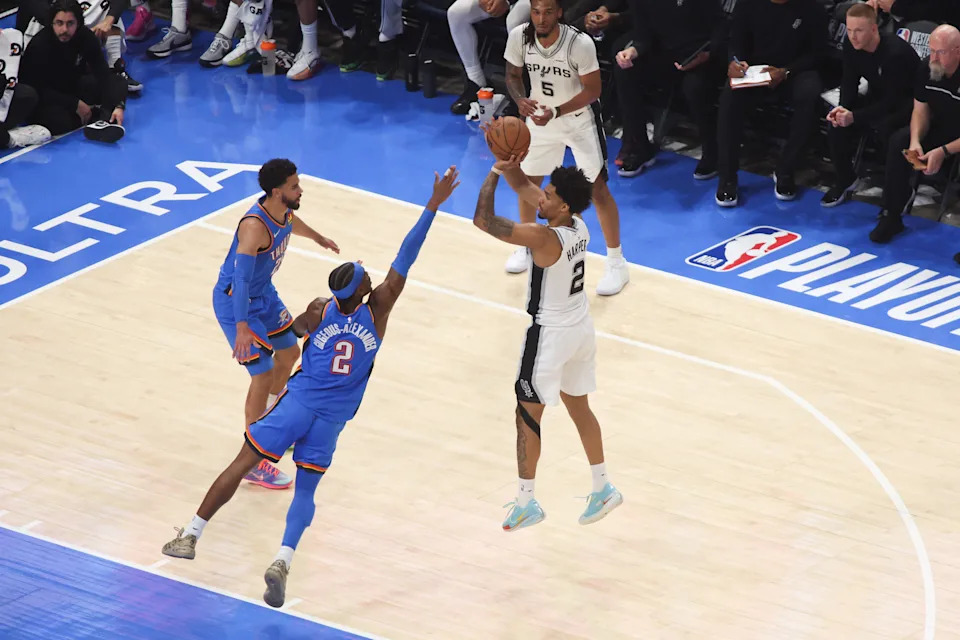 May 20, 2026; Oklahoma City, Oklahoma, USA; San Antonio Spurs guard Dylan Harper (2) shoots as Oklahoma City Thunder guard Shai Gilgeous-Alexander (2) defends during the second quarter during game two of the western conference finals for the 2026 NBA playoffs at Paycom Center. Mandatory Credit: Brett Rojo-Imagn Images