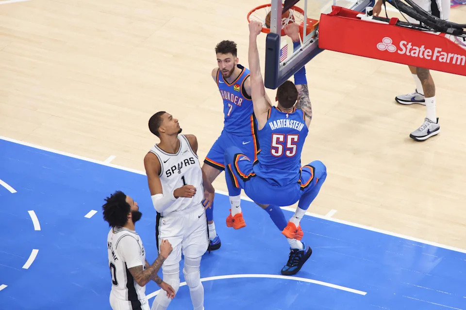 May 20, 2026; Oklahoma City, Oklahoma, USA; Oklahoma City Thunder center Isaiah Hartenstein (55) dunks over San Antonio Spurs forward Victor Wembanyama (1) during the second quarter during game two of the western conference finals for the 2026 NBA playoffs at Paycom Center. Mandatory Credit: Brett Rojo-Imagn Images