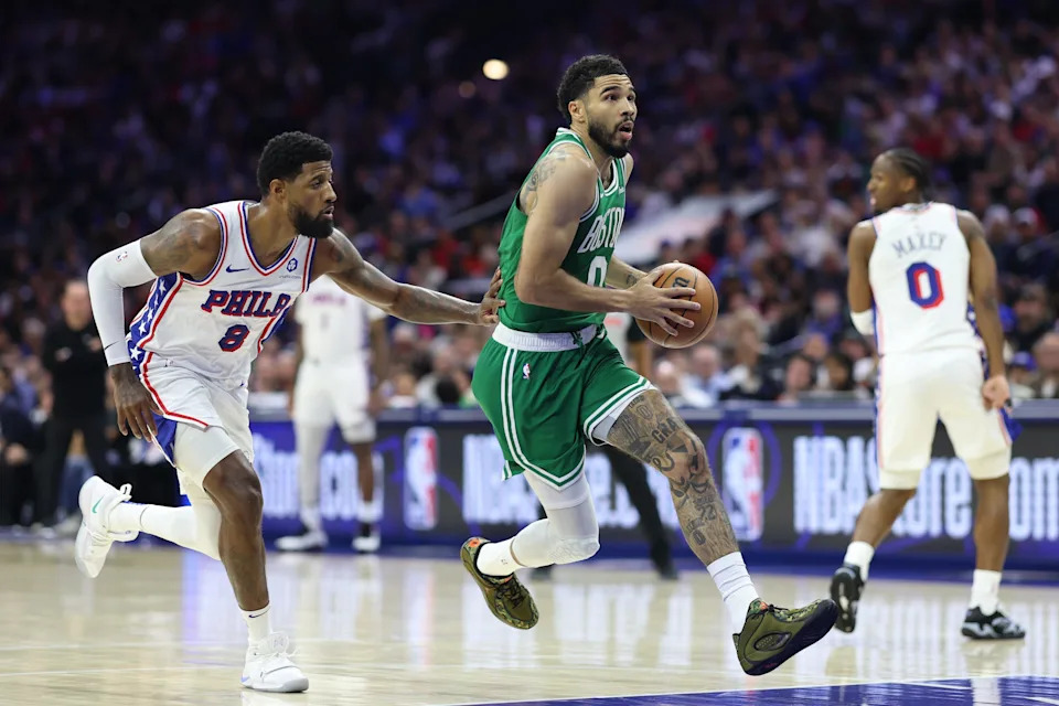 Apr 30, 2026; Philadelphia, Pennsylvania, USA; Boston Celtics forward Jayson Tatum (0) drives past Philadelphia 76ers forward Paul George (8) during the first quarter at Xfinity Mobile Arena. Mandatory Credit: Bill Streicher-Imagn Images