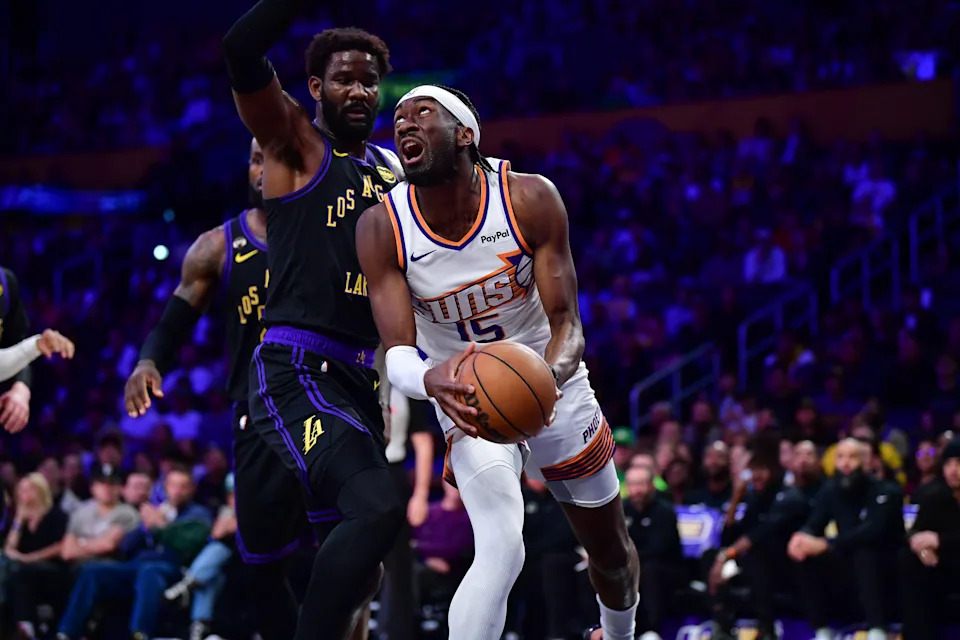 Phoenix Suns center Mark Williams (15) moves to the basket against Los Angeles Lakers center Deandre Ayton (5) during the first half at Crypto.com Arena in Los Angeles, on April 10, 2026.