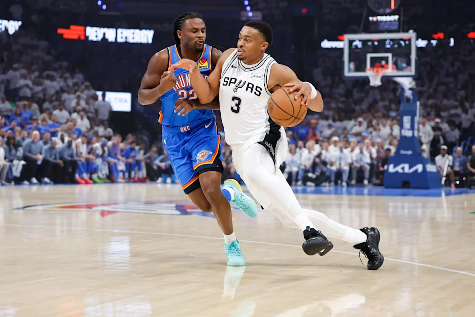 May 20, 2026; Oklahoma City, Oklahoma, USA; San Antonio Spurs forward Keldon Johnson (3) drives to the basket as Oklahoma City Thunder guard Cason Wallace (22) defends during the first quarter during game two of the western conference finals for the 2026 NBA playoffs at Paycom Center. Mandatory Credit: Alonzo Adams-Imagn Images