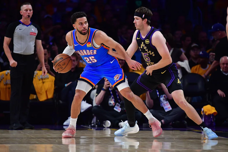 May 11, 2026; Los Angeles, California, USA; Oklahoma City Thunder guard Ajay Mitchell (25) moves the ball against Los Angeles Lakers guard Austin Reaves (15) during the first half in game four of the second round of the 2026 NBA Playoffs at Crypto.com Arena. Mandatory Credit: Gary A. Vasquez-Imagn Images