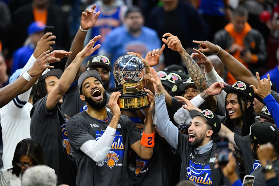 Karl-Anthony Towns lifts the Eastern Conference finals trophy with teammates.