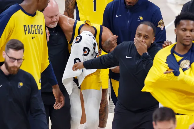 Indiana Pacers guard Tyrese Haliburton (0) is assisted after an apparent injury following a play against the Oklahoma City Thunder during the first half of game seven of the 2025 NBA Finals at Paycom Center.
