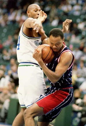 DALLAS, TX - MARCH 27: Tim Breaux of the Houston Rockets (R) wrestles a rebound away from Dallas Maverick Popeye Jones during first half action at Reunion Arena in Dallas, Texas 27 March. The Mavericks beat the Rockets 117-114. (Photo credit should read AFP/AFP via Getty Images)