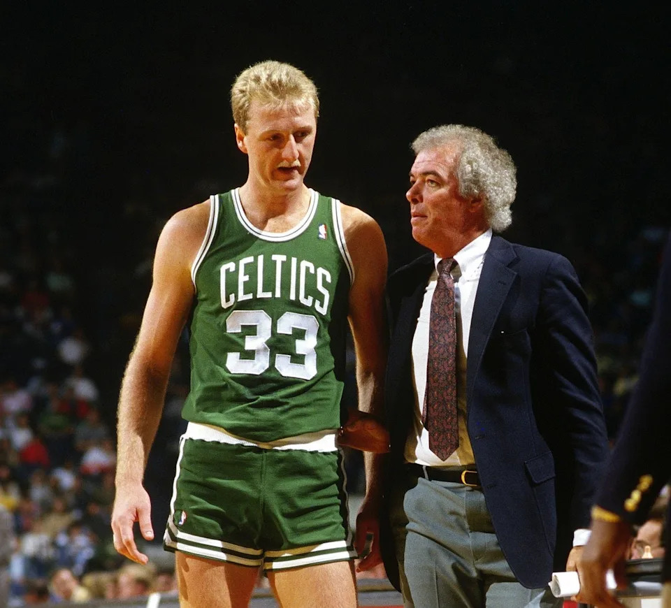 LANDOVER, MD - CIRCA 1989: Larry Bird #33 of the Boston Celtics talks with head coach Jimmy Rodgers while there's a break in the action against the Washington Bullets during an NBA basketball game circa 1989 at the Capital Center in Landover, Maryland. Bird played for the Celtics from 1979-92. (Photo by Focus on Sport/Getty Images)
