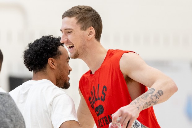 Chicago Bulls guard Tre Jones embraces forward Matas Buzelis during an introductory press conference hosted by the Chicago Bulls for Bryson Graham, the new Executive Vice President - Basketball Operations at the Advocate Center Wednesday May 6, 2026. (Josh Boland/Chicago Tribune)