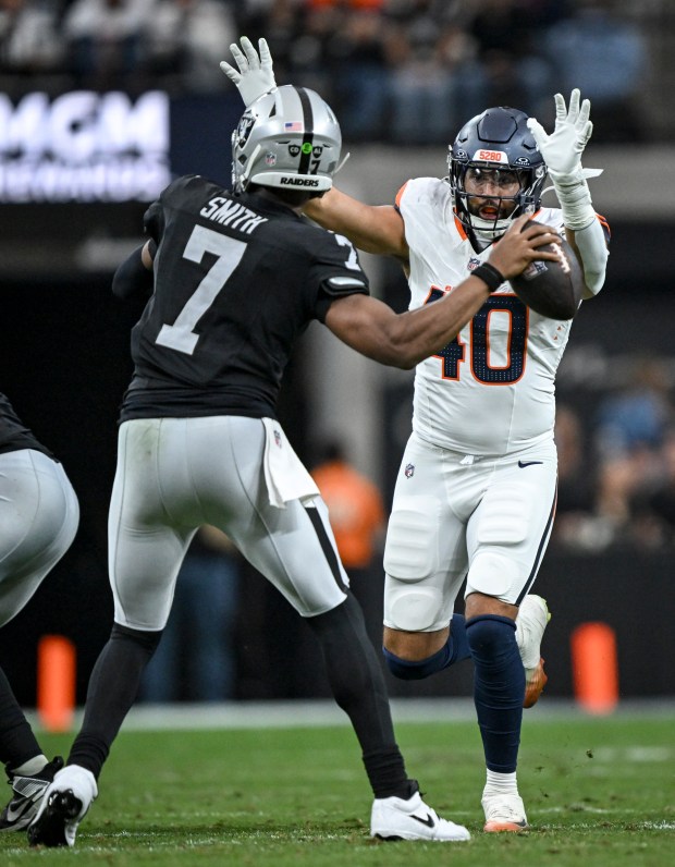 Justin Strnad (40) of the Denver Broncos pressures Geno Smith (7) of the Las Vegas Raiders during the second quarter at Allegiant Stadium in Las Vegas, Nevada on Sunday, Dec. 7, 2025. (Photo by AAron Ontiveroz/The Denver Post)