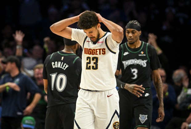 Cameron Johnson (23) of the Denver Nuggets reacts to fouling Jaden McDaniels (3) of the Minnesota Timberwolves during the fourth quarter of the Timberwolves' 110-98 Game 6 first round NBA Playoffs series win at the Target Center in Minneapolis, Minnesota on Thursday, April 30, 2026. Minnesota eliminated the Nuggets 4-2. (Photo by AAron Ontiveroz/The Denver Post)