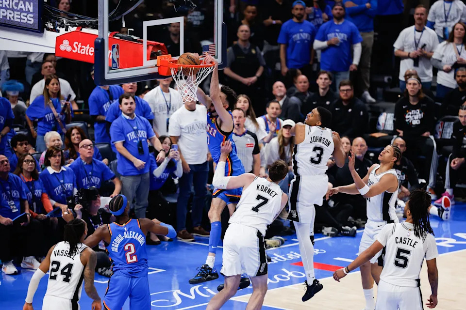 May 20, 2026; Oklahoma City, Oklahoma, USA; Oklahoma City Thunder center Chet Holmgren (7) dunks as San Antonio Spurs center Luke Kornet (7) defends during the third quarter during game two of the western conference finals for the 2026 NBA playoffs at Paycom Center. Mandatory Credit: Alonzo Adams-Imagn Images