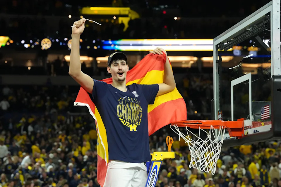 Apr 6, 2026; Indianapolis, IN, USA; Michigan Wolverines center Aday Mara (15) celebrates after cutting down a piece of the net after defeating the Connecticut Huskies in the national championship of the Final Four of the men's 2026 NCAA Tournament at Lucas Oil Stadium. Mandatory Credit: Robert Deutsch-Imagn Images