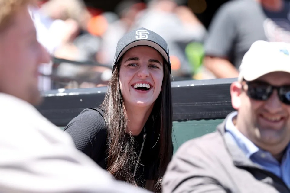 Clark was donning a black and white Giants cap next to their dugout, speaking with Podziemski, who was sitting right in front of her during the game. Getty Images