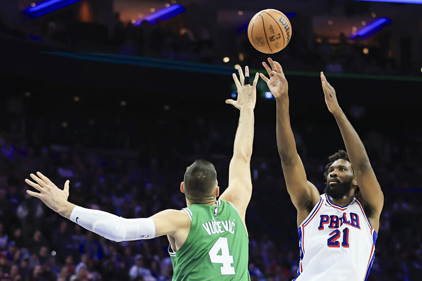 Joel Embiid, #21 of the Philadelphia 76ers, shoots the ball as Nikola Vucevic, #4 of the Boston Celtics, defends at the NBA Playoffs game.